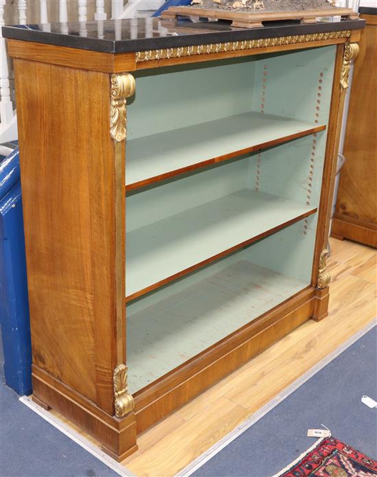 A pair of Victorian design parcel gilt walnut open bookcases W.124cm